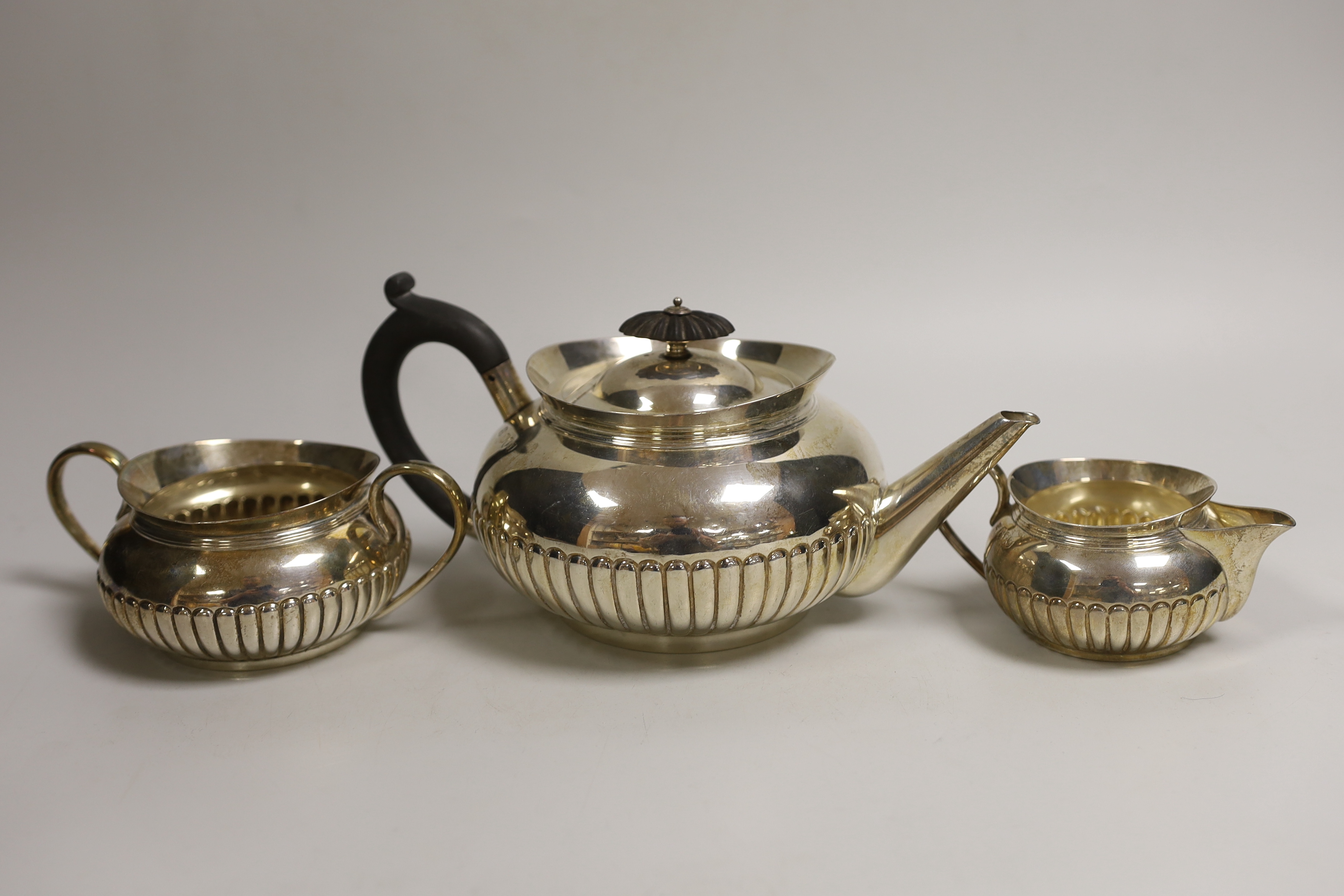 A late Victorian demi-fluted silver three piece tea set, Hukin & Heath, London, 1893/4/5, gross weight 27.6oz.